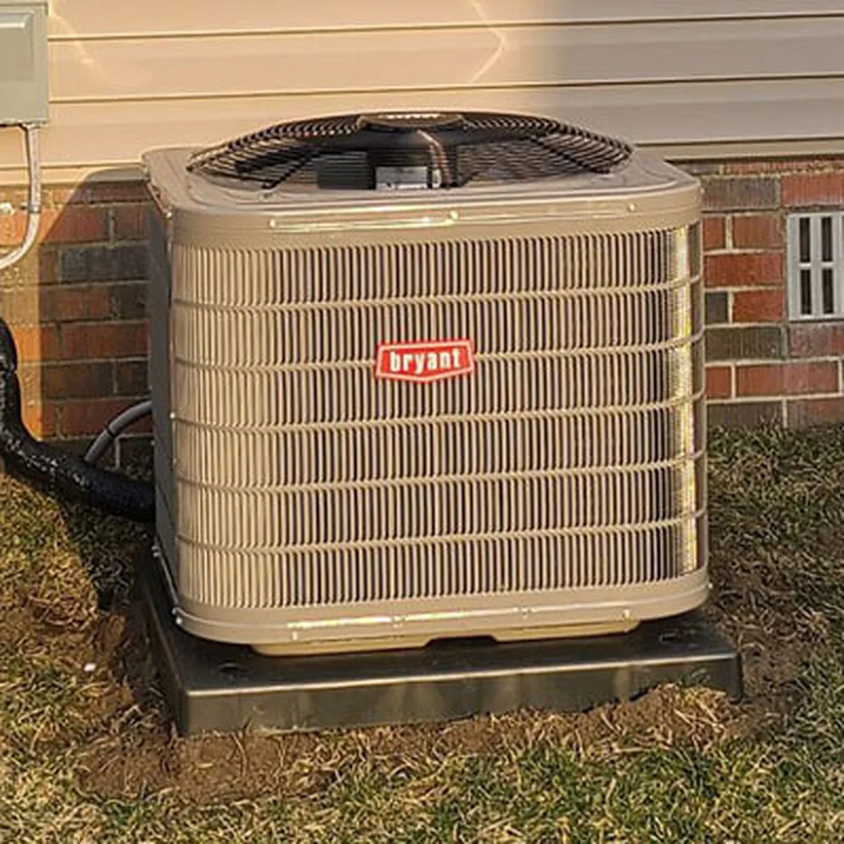 Residential HVAC condenser unit installed beside a Michigan home